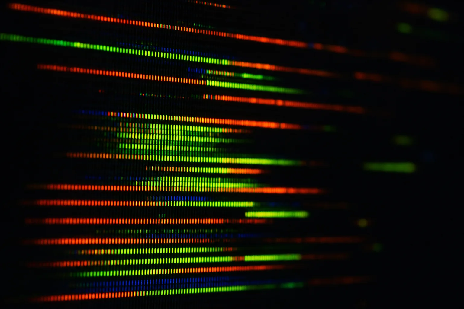 Extreme macro of CRT phosphor stripes mid-glitch in green and red — still from the Signal Decay title sequence